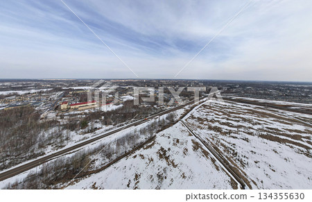 drone captures peaceful winter rural scenery, remote snowcovered fields with winding path 134355630