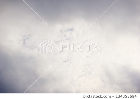 Dramatic sky with a vast expanse of grey and white textured storm clouds and soft light 134355684