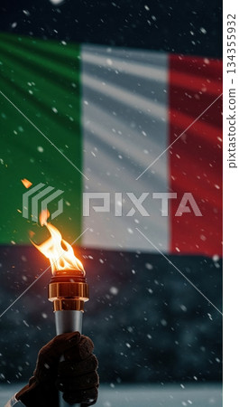 A gloved hand firmly holds a brightly burning torch against the backdrop of a waving Italian flag during a snowy winter night ceremony. 134355932