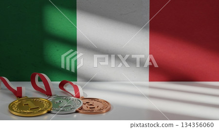Three gleaming gold, silver, and bronze medals with red and white ribbons rest on a white surface before a textured Italian flag wall with prominent shadows. 134356060