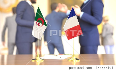 Algeria and France diplomatic desk flags during talks, 3D rendering Algeria and France diplomatic desk flags during talks, 3D rendering 134356191