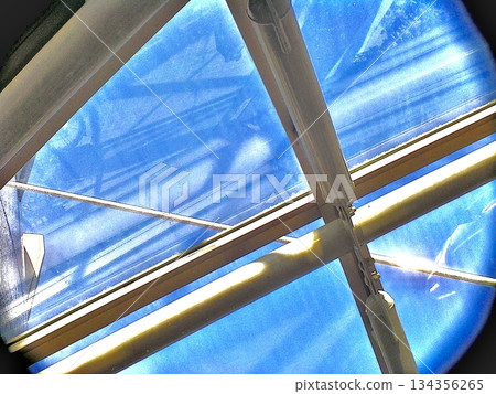 Blue sky and light lines seen through a skylight | Architectural and abstract background material 134356265