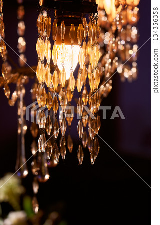 Glamorous Chandelier Illuminates Grand Room, Crystal Pendant Lights Cast Warm Amber Glow Everywhere 134356358