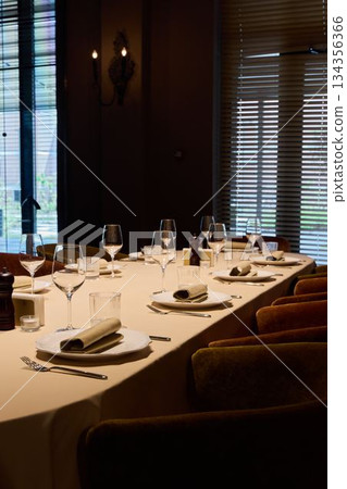 celebration setup ready, group gathering featuring meticulous table decor and lighting effects celebration setup ready, group gathering featuring meticulous table decor and lighting effects 134356366
