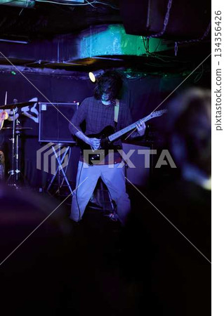 Silent Musician With Atmospheric Lighting, Subtle Musician In Dim Lighting With Deep Bass Fundamentals 134356426