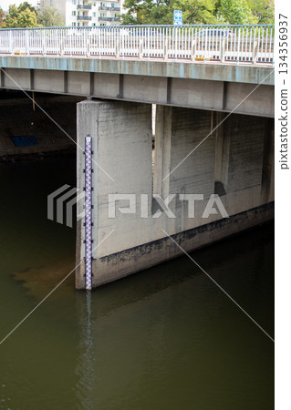 Water level measurement near a concrete bridge shows clear indicator of river Water level measurement near a concrete bridge shows clear indicator of river 134356937