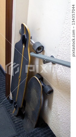 Skateboards resting against a wall in a hallway after a day of riding Skateboards resting against a wall in a hallway after a day of riding 134357044