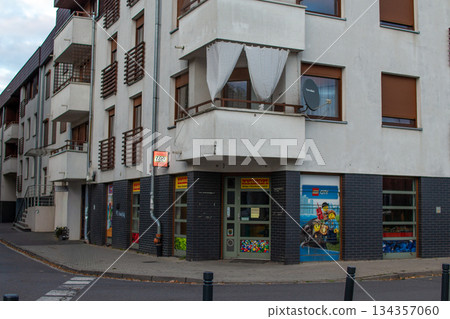 Brightly colored building with art-themed storefront in a residential area 134357060