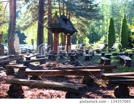 Outdoor seating area surrounded by trees offers a peaceful spot for gatherings 134357065