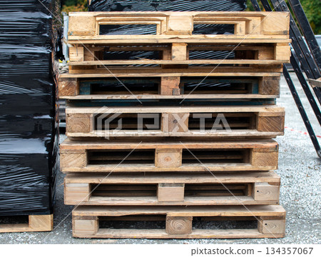 Wooden pallets stacked in a warehouse ready for distribution and transport  134357067