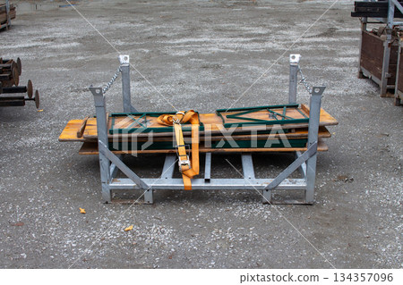 Beer garden tables secured on a rack, ready for outdoor events in park setting 134357096