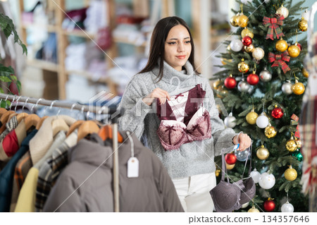 Young woman chooses lingerie in clothing store 134357646