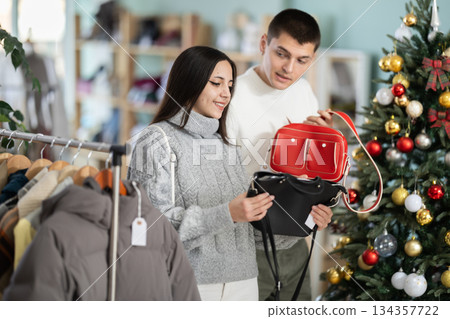 Young couple chooses handbag in store 134357722