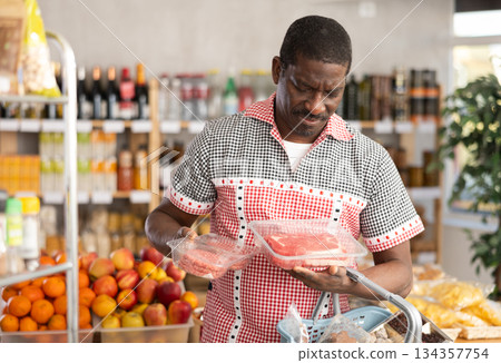 Adult man choosing hamburger or entrecote in grocery store 134357754