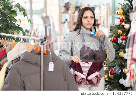 Young girl choosing bra in clothing store Young girl choosing bra in clothing store 134357775