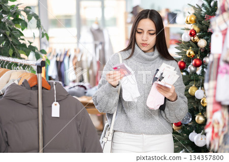 Young girl choosing socks in clothing store Young girl choosing socks in clothing store 134357800
