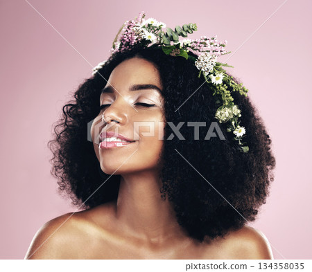 Woman, face and flower crown for beauty in studio, pink background and natural glowing skincare. African, female model and floral wreath of plants, sustainable cosmetics and eco friendly dermatology Woman, face and flower crown for beauty in studio, pink background and natural glowing skincare. African, female model and floral wreath of plants, sustainable cosmetics and eco friendly dermatology 134358035