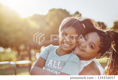 Woman, young girl outdoor with smile in portrait and love, bonding in park with happiness and care. Relationship, mother and daughter spending quality time together with embrace, affection and family 134358057