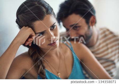 Conflict, upset or sad with a couple arguing on a sofa in their home living room about an affair or breakup. Depression, unhappy or domestic violence with a woman thinking about divorce after a fight 134358071