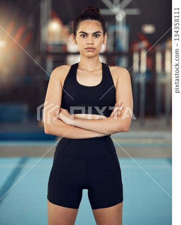 Portrait of fitness, exercise and workout woman in sport training for health and fit body in a gym. Serious, healthy or strong athlete with motivation or wellness before cardio routine in sports club Portrait of fitness, exercise and workout woman in sport training for health and fit body in a gym. Serious, healthy or strong athlete with motivation or wellness before cardio routine in sports club 134358111