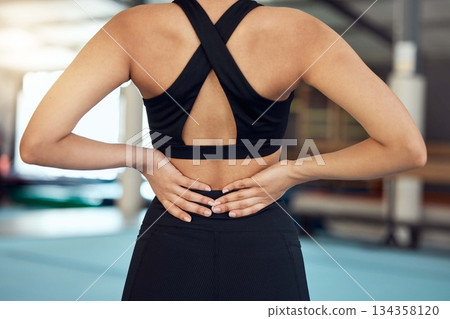 Exercise pain, workout and fitness sports woman with a back injury after training at a boxing gym. Wellness, health or yoga club with a sport athlete person holding her body from joint inflammation Exercise pain, workout and fitness sports woman with a back injury after training at a boxing gym. Wellness, health or yoga club with a sport athlete person holding her body from joint inflammation 134358120
