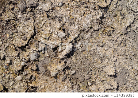 Cracked dry ground surface texture background with small gravel details Cracked dry ground surface texture background with small gravel details 134359385
