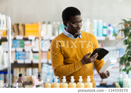Adult man scanning qr code of cream 134359570