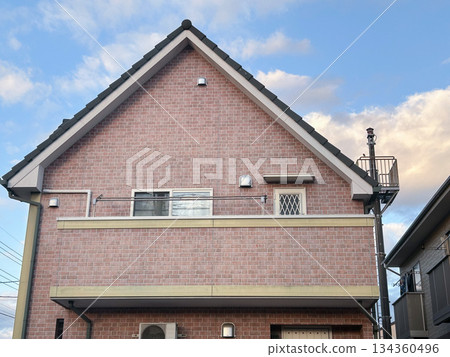 A detached house with a gable roof and brick-style siding exterior A detached house with a gable roof and brick-style siding exterior 134360496