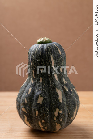Green butternut squash pumpkin on brown background 134361616