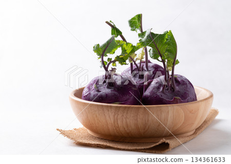 Purple kohlrabi or turnip cabbage in wooden bowl on white background Purple kohlrabi or turnip cabbage in wooden bowl on white background 134361633