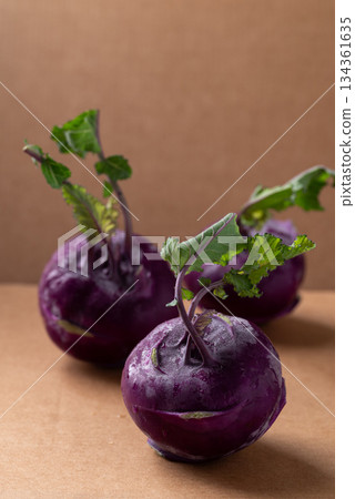 Purple kohlrabi or turnip cabbage on brown background Purple kohlrabi or turnip cabbage on brown background 134361635