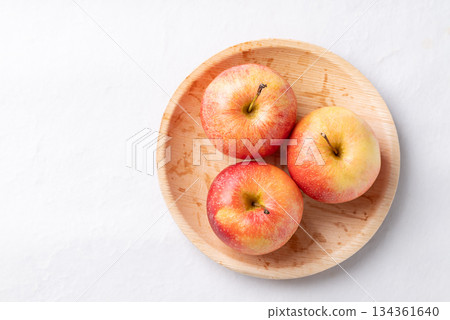 Red apple fruit (Gala apple) in natural plate on white background, Top view 134361640