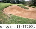 Scenery view of bunker in golf course. A bunker is positioned in the golf hole to guard the desired position in the landing area or green. 134361901