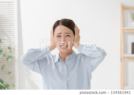 A woman clogging the ear A woman clogging the ear 134361941