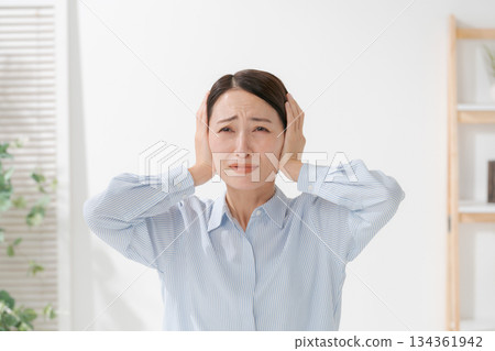 A woman clogging the ear 134361942