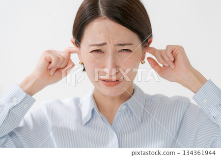 A woman clogging the ear A woman clogging the ear 134361944