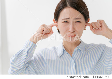 A woman clogging the ear 134361945