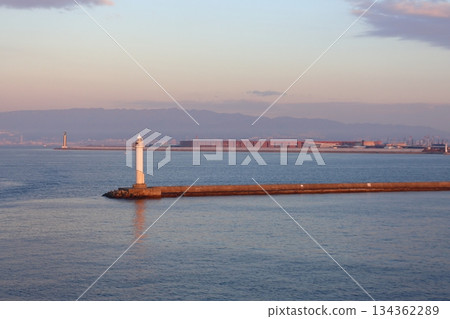 Osaka North Port South Breakwater Lighthouse and the large roof ring of the Osaka Expo in the morning glow Osaka North Port South Breakwater Lighthouse and the large roof ring of the Osaka Expo in the morning glow 134362289