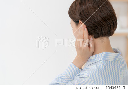 Back view of a woman covering her ears 134362345