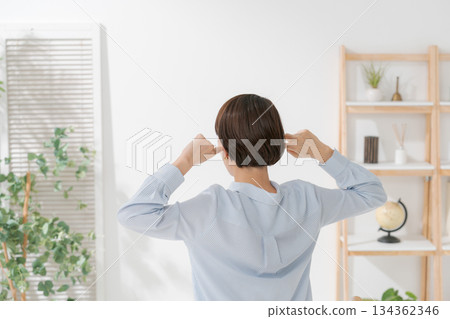 Back view of a woman covering her ears 134362346