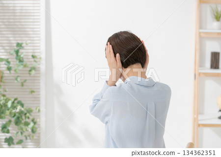 Back view of a woman covering her ears 134362351