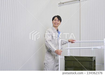 Worker carrying a cart 134362376