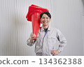 Worker holding a traffic cone, warehouse, portrait, looking at camera 134362388