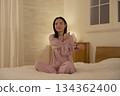 Woman stretching her arms on the bed 134362400