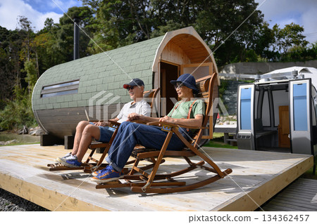 Senior couple relaxing in rocking chairs [Photo courtesy of Oki Seaside Hotel Miyabi] 134362457