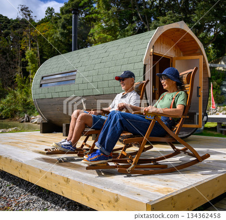 An elderly couple in front of the sauna hut [Photo courtesy of Oki Seaside Hotel Miyabi] 134362458