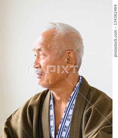 Senior man in Japanese clothing, thinking in profile 134362464