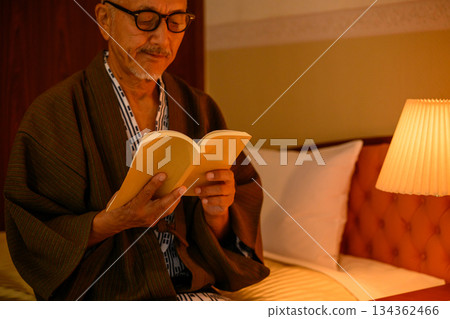 An elderly man reading in traditional Japanese clothing 134362466
