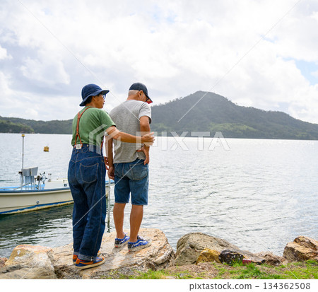 A senior couple standing close together by the water (Photo courtesy of Oki Seaside Hotel Miyabi) A senior couple standing close together by the water (Photo courtesy of Oki Seaside Hotel Miyabi) 134362508