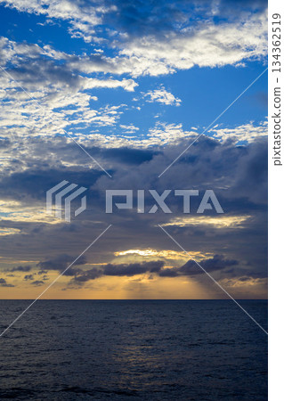 The sunset sea and sky breaking through the dark clouds 134362519